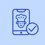 Tablet displaying chef icon with tick, representing kitchen routing and order confirmation”